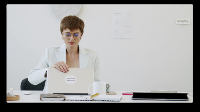 a woman sitting at a desk with a laptop