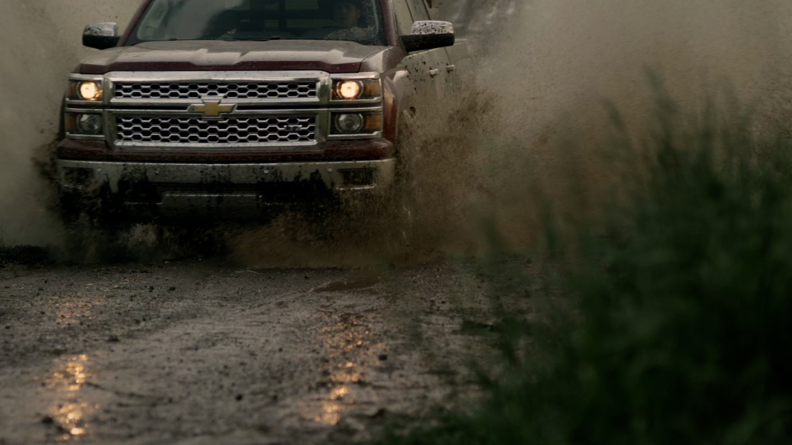 a truck driving through a puddle of water