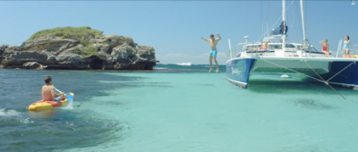 a group of people in the water near a boat