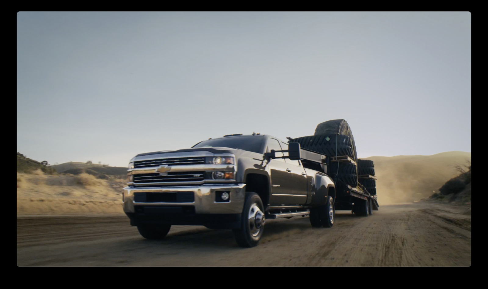 a large truck driving down a dirt road