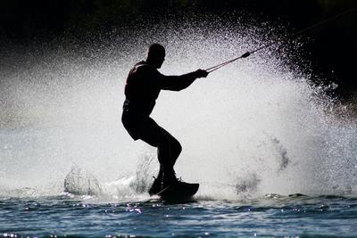 a man riding a board on top of a wave