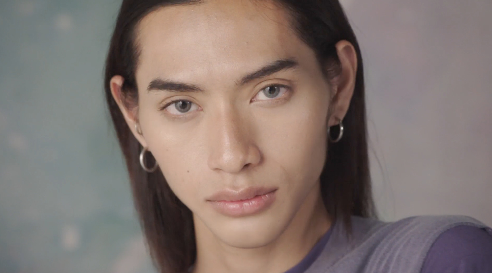 a close up of a person wearing earrings