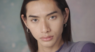 a close up of a person wearing earrings