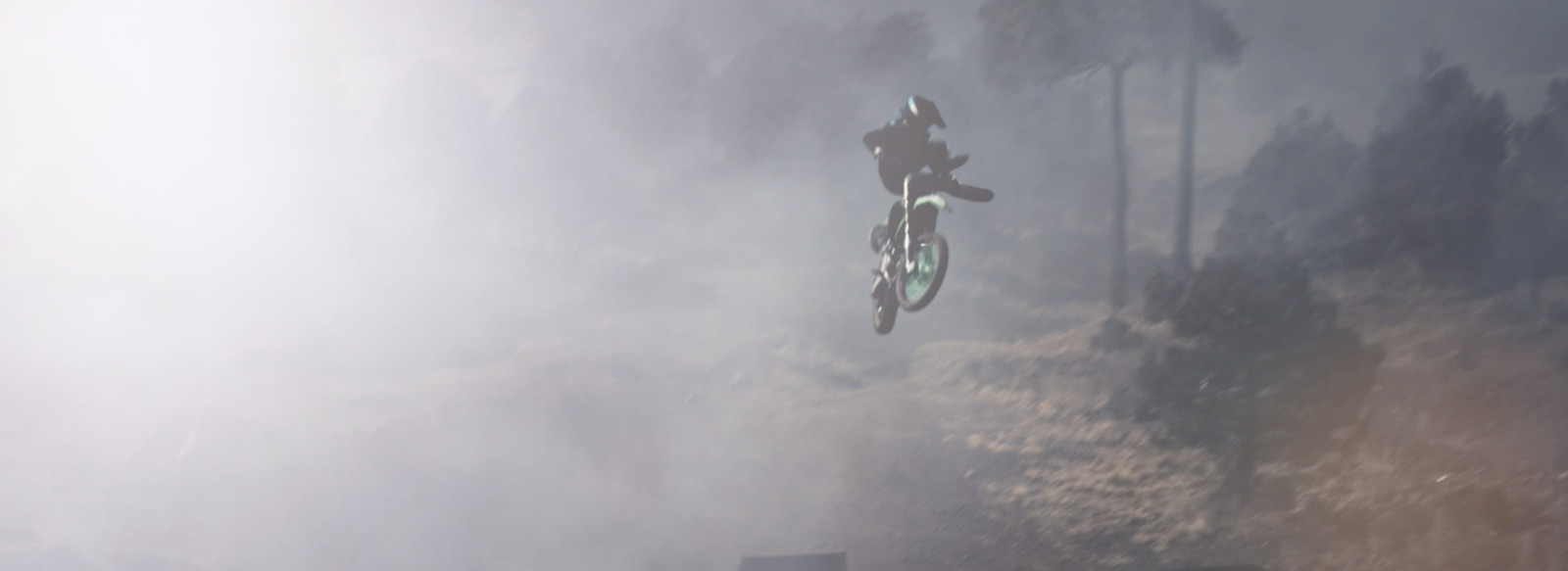 a man flying through the air while riding a bike