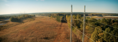 an aerial view of a field and power lines