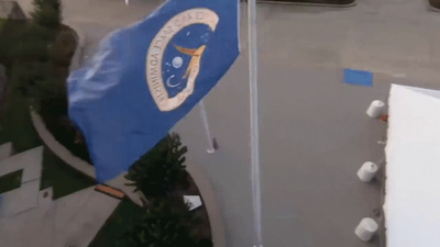 a blue and white flag on a pole