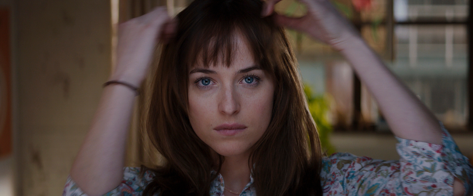 a woman is holding her hair in front of her head