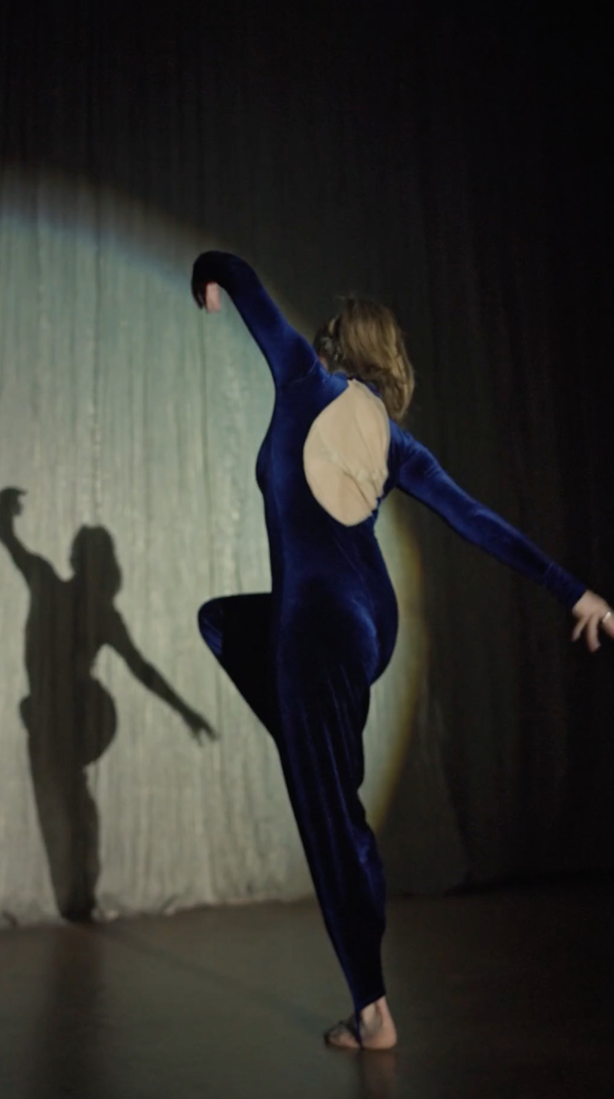 a woman in a blue dress is dancing