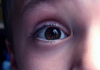 a close up of a child's brown eye