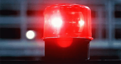 a red traffic light sitting on top of a table