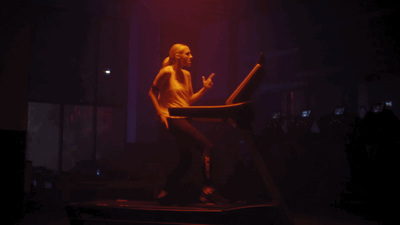 a woman standing on a chair in the dark