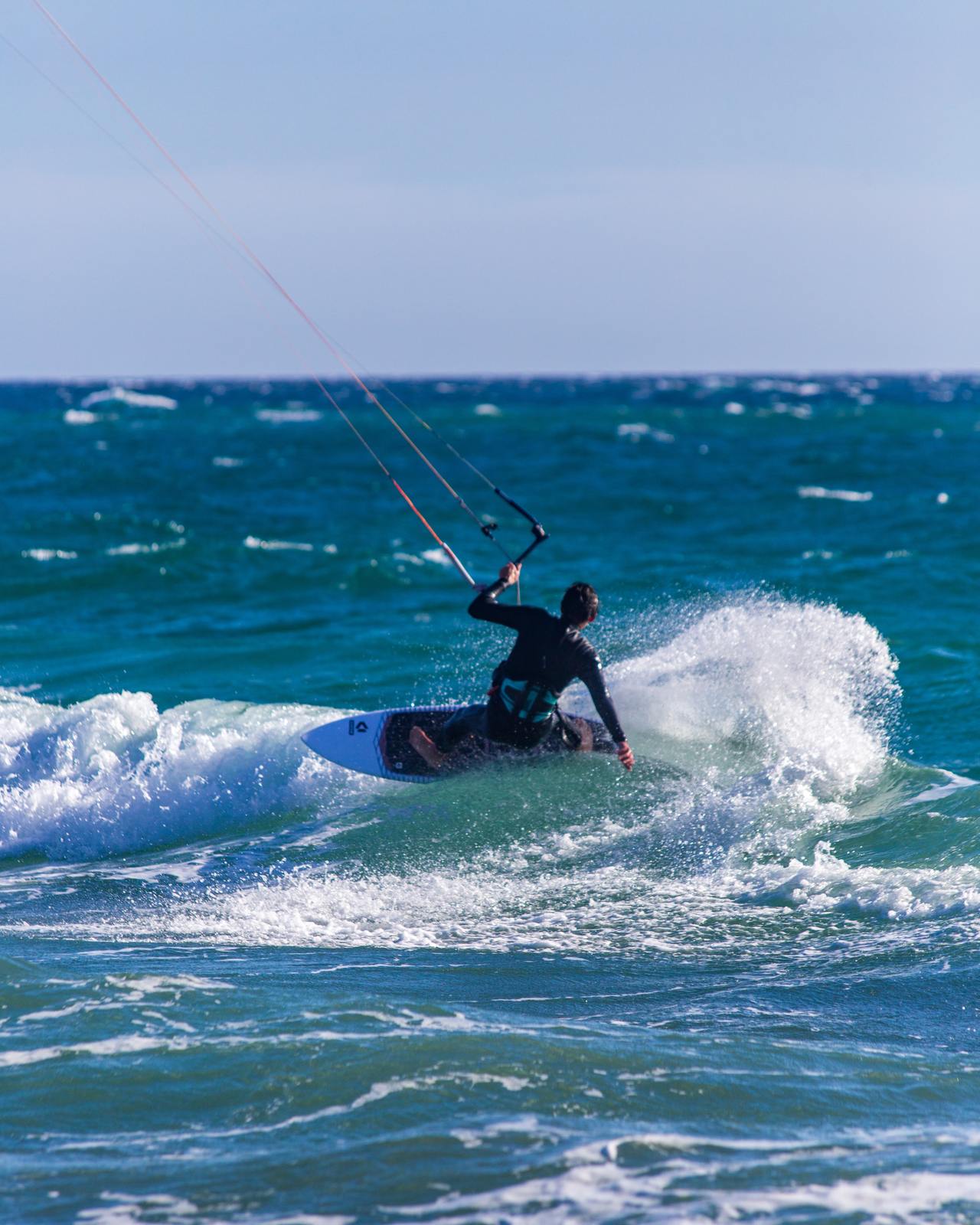 a man riding a surfboard on top of a wave