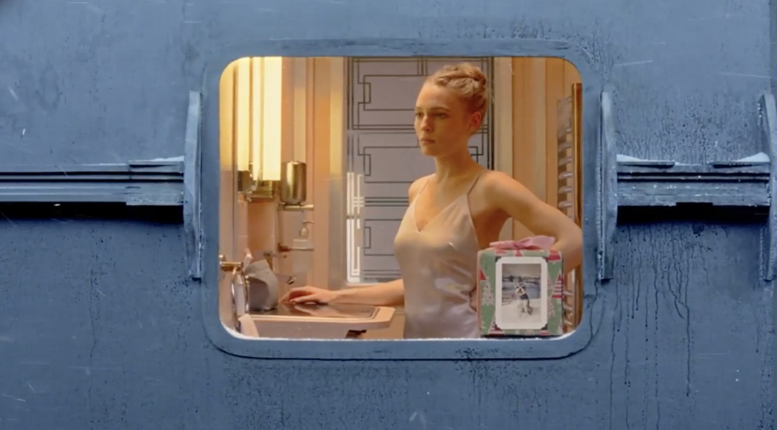 a woman standing in front of a sink in a bathroom