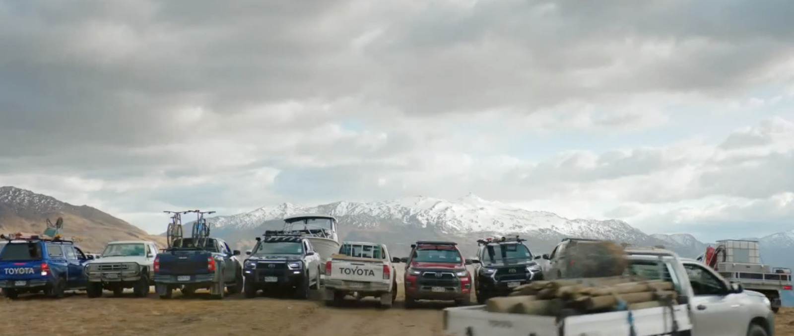 a group of trucks parked on a dirt road