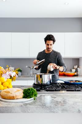 a man is pouring something into a pot