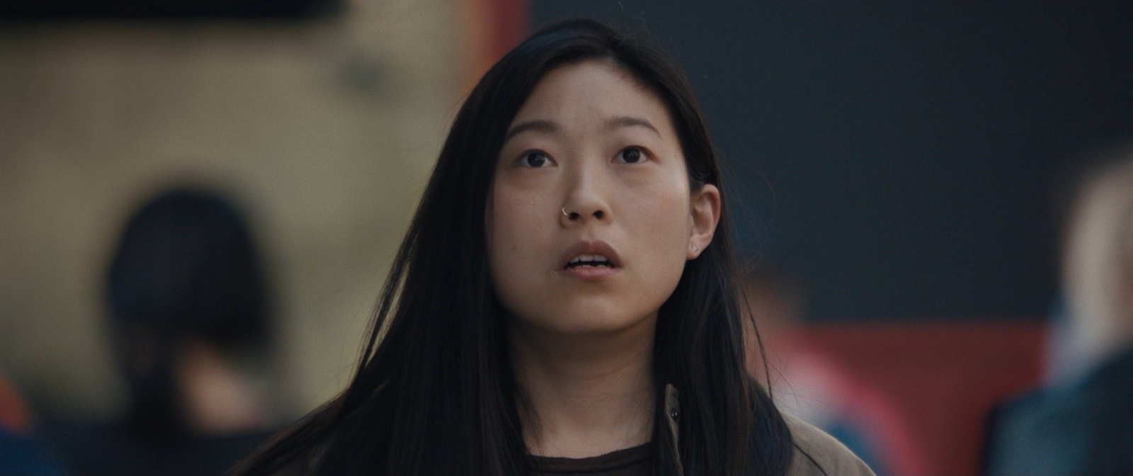 a woman with long black hair looking up