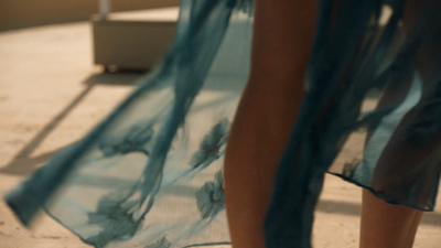 a woman in a blue dress standing next to a toilet