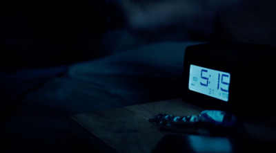 a clock sitting on top of a wooden table