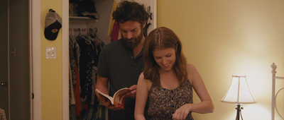 a man and a woman looking at a book