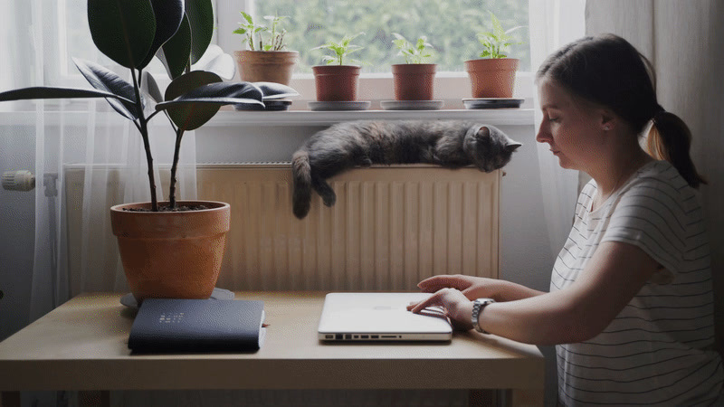 a woman sitting in front of a laptop computer