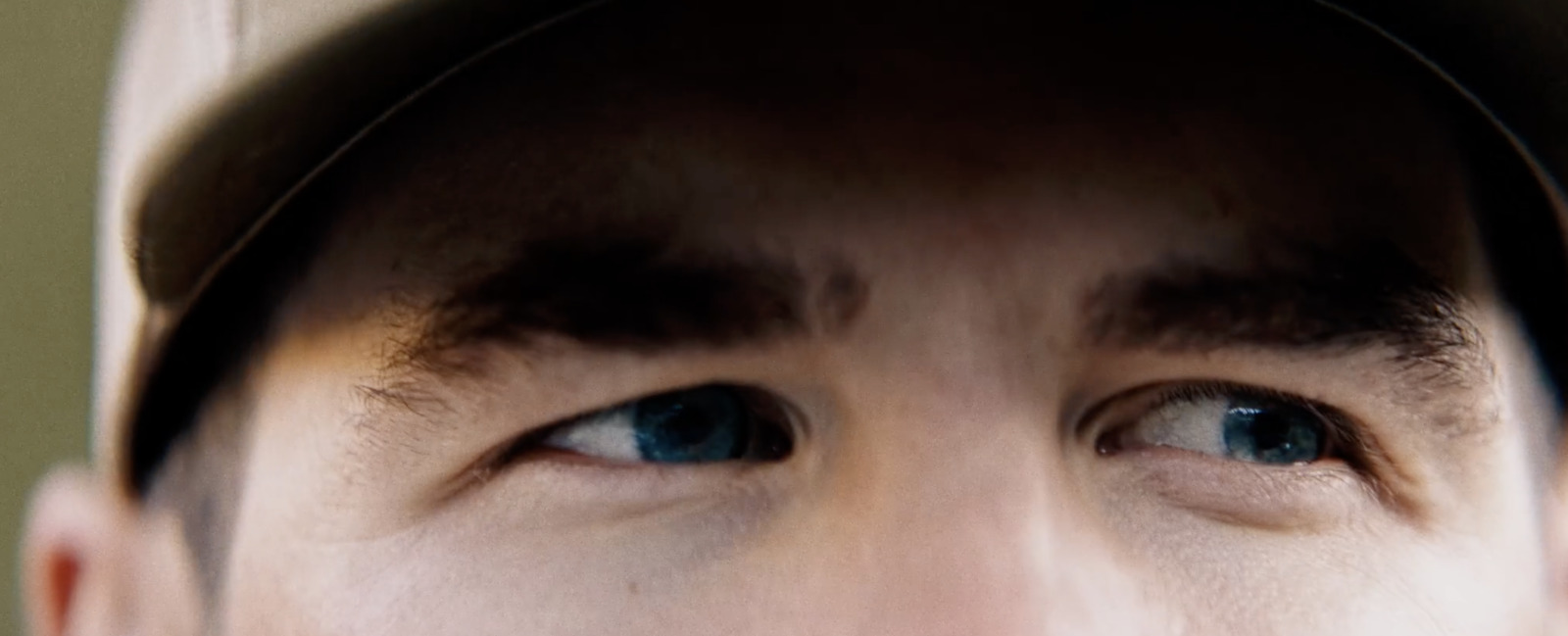 a close up of a person wearing a baseball cap