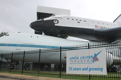 a space shuttle on top of a large airplane