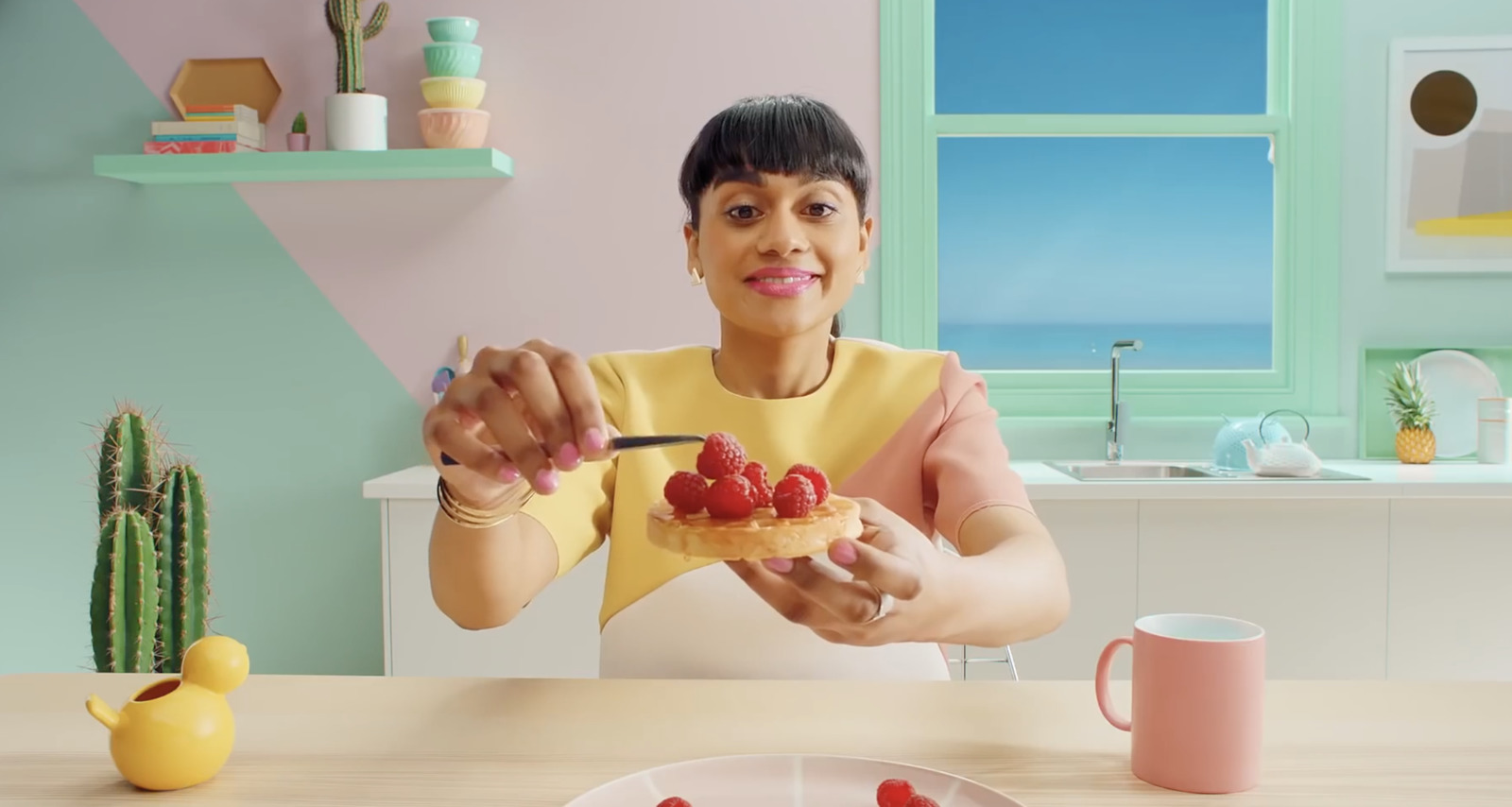 a woman sitting at a table with a plate of food