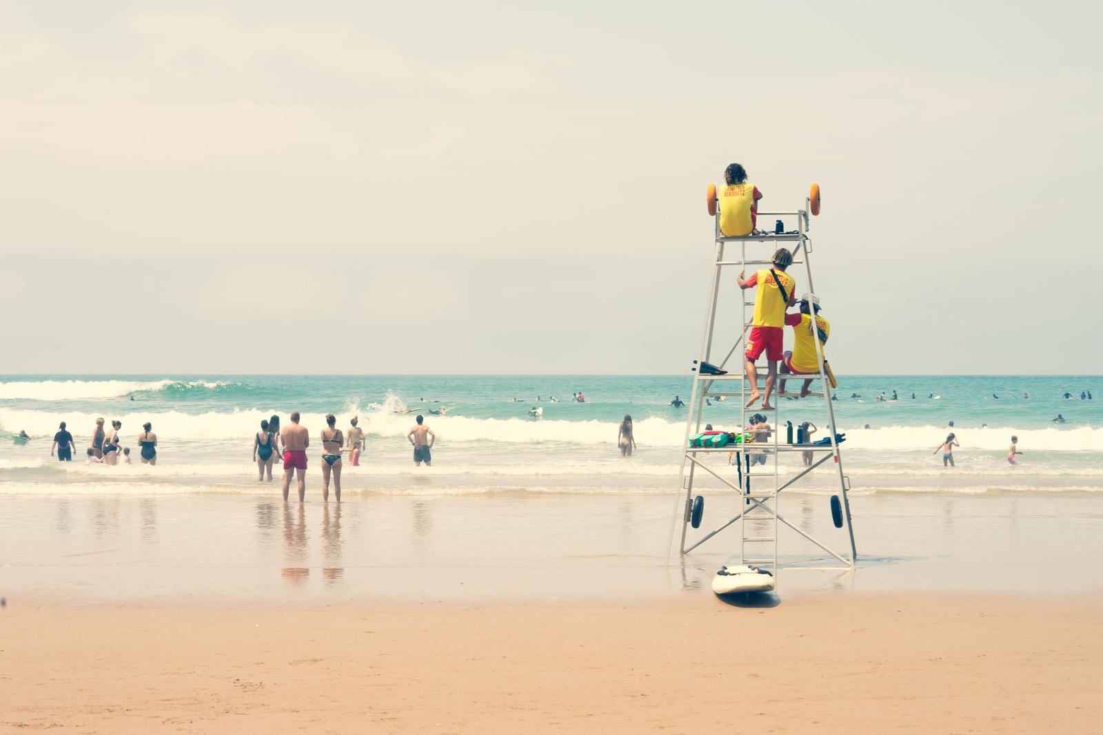 a group of people standing on top of a lifeguard tower