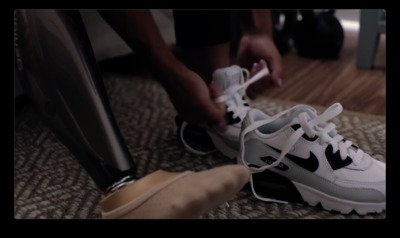 a person tying a pair of white and black sneakers