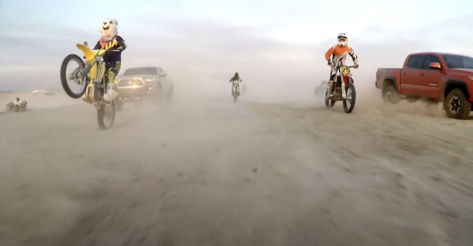 a group of people riding bikes down a dirt road