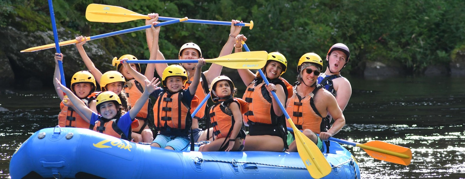 a group of people riding on the back of a raft