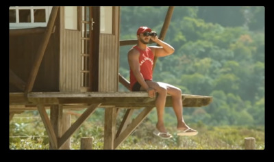 a man sitting on top of a wooden structure