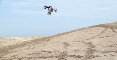 a man flying through the air while riding a motorcycle