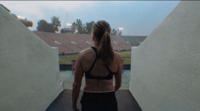 a woman in a sports bra top walking up a ramp