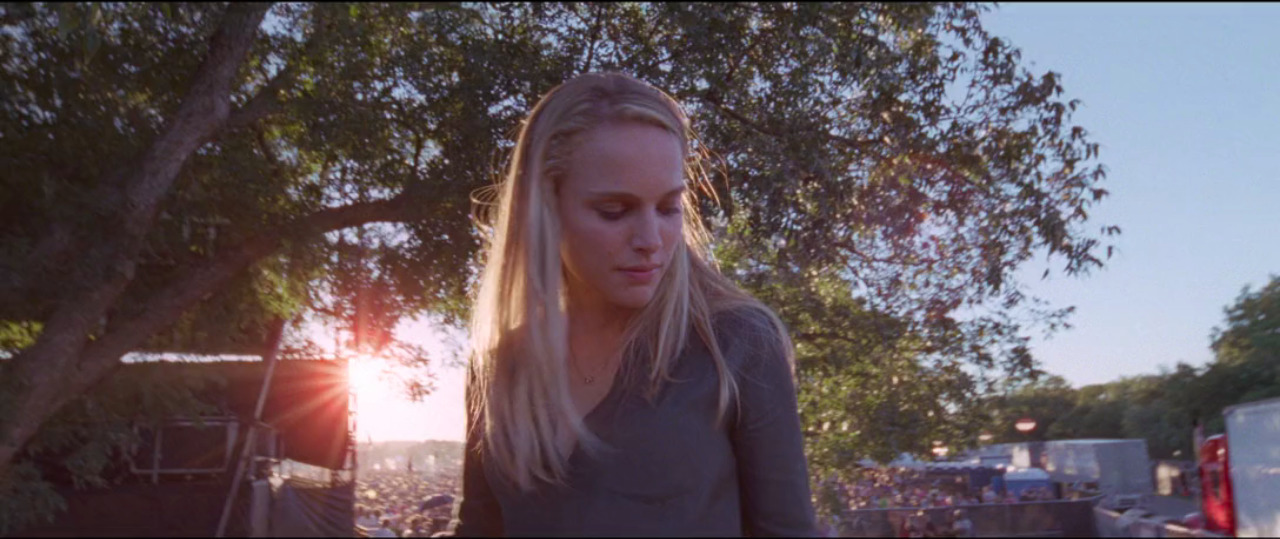 a woman standing in front of a tree