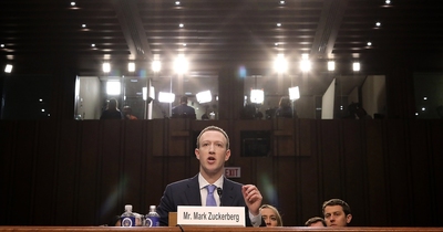 a man in a suit and tie sitting at a table