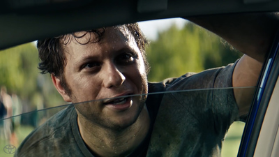 a man looking out the window of a car