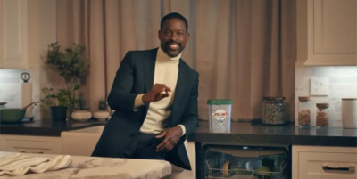 a man in a suit standing in a kitchen