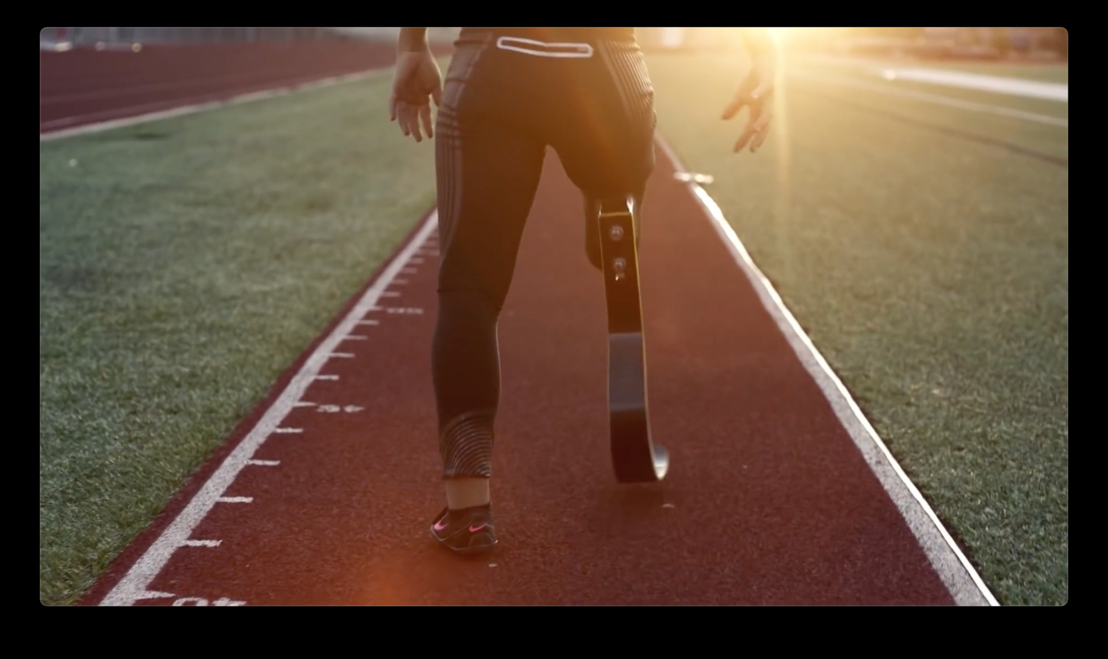 a person walking on a track with a skateboard