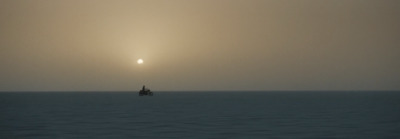 a lone boat in the middle of a large body of water