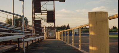 a row of bleachers sitting next to a baseball field