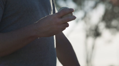 a close up of a person holding a ball