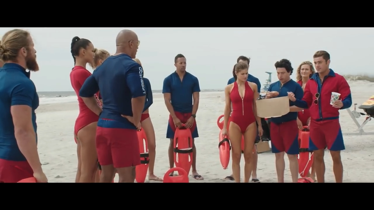 a group of people standing on top of a beach