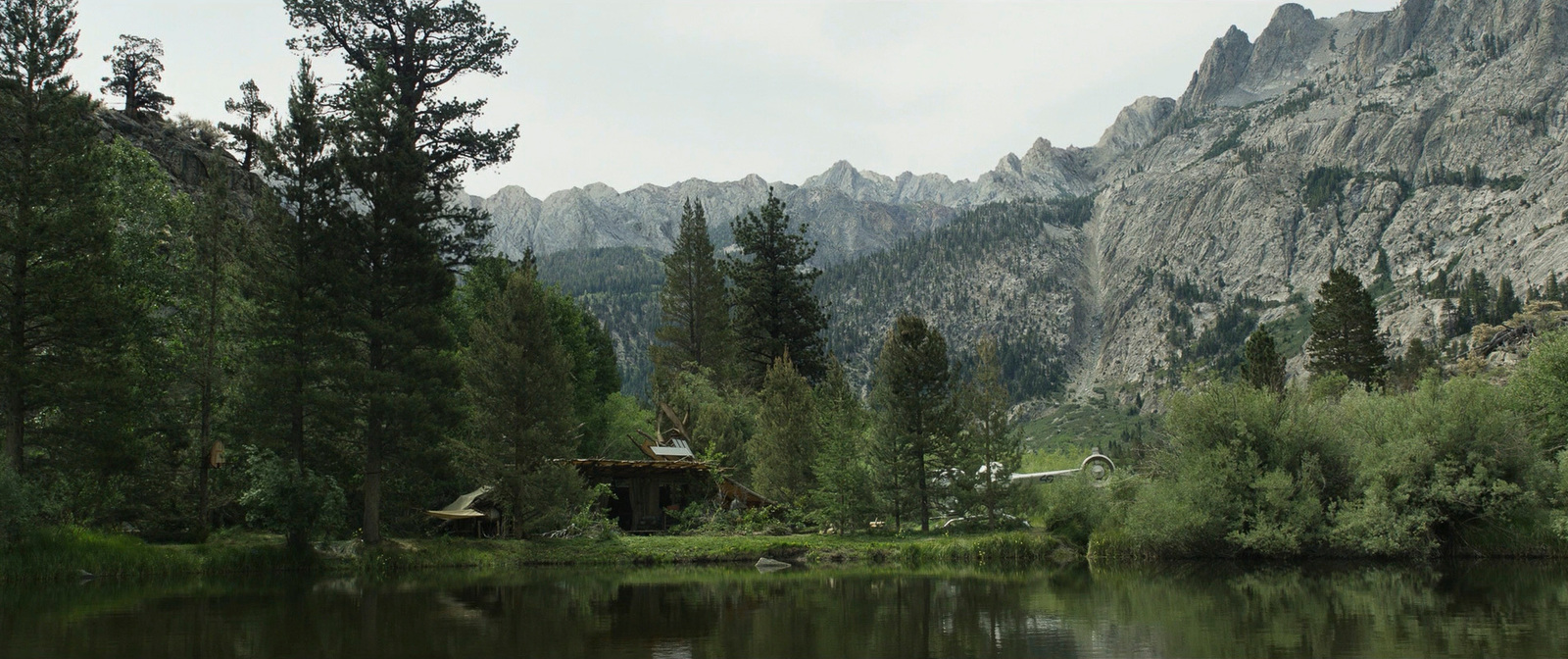 a lake surrounded by trees and mountains