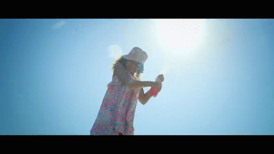 a little girl in a dress and hat holding a bat