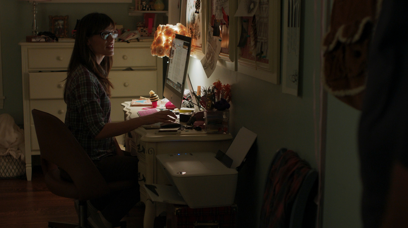 a woman sitting at a desk in a room