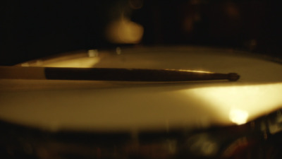 a close up of a drum with a wooden stick