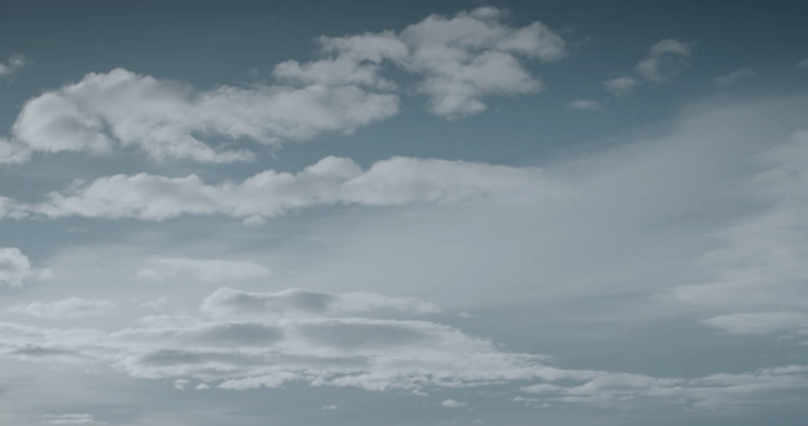 a plane flying in the sky with clouds