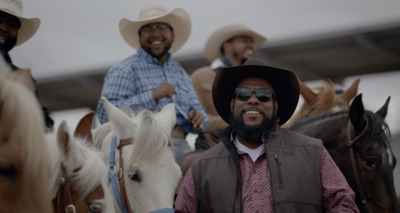 a group of men riding on the backs of horses