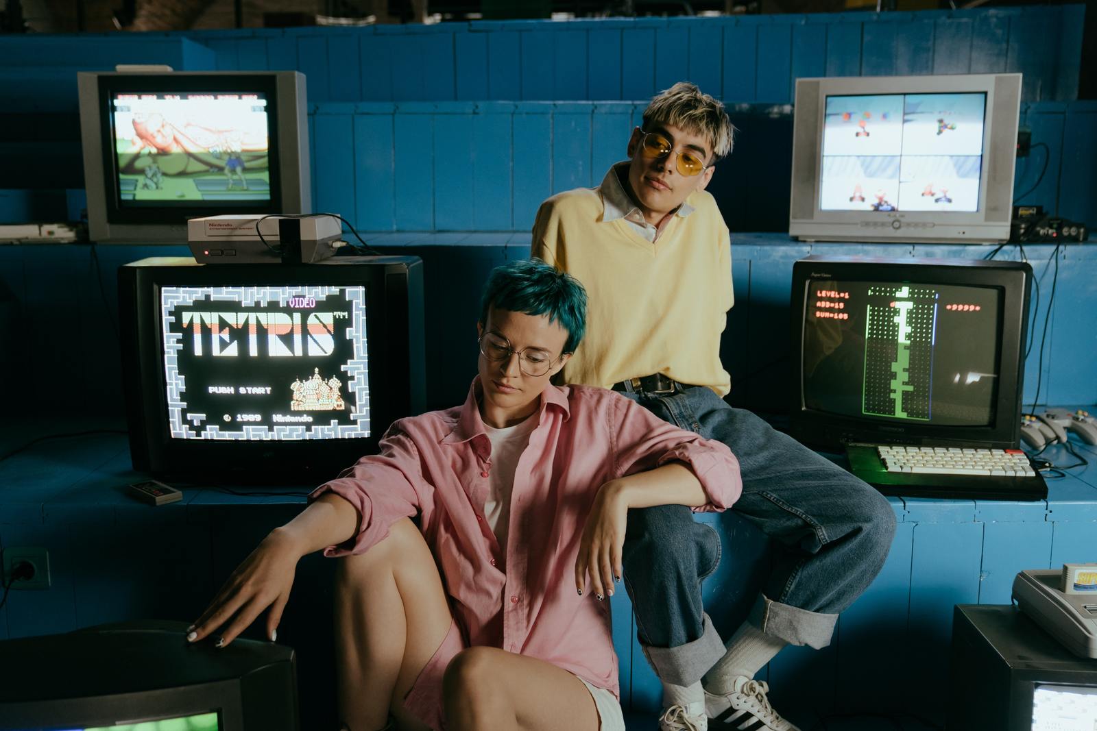 a man and a woman sitting in front of computer monitors